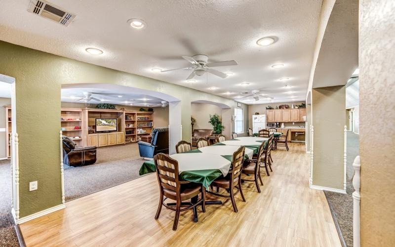 a large dining room with a wood floor