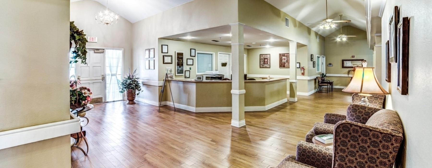 a large living room with a large chandelier and a large kitchen